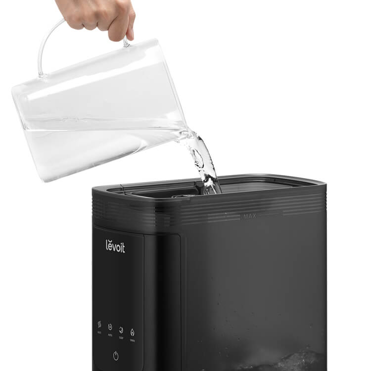 Refilling the Levoit Smart Humidifier with water using the easy top-fill design for quick and hassle-free maintenance
