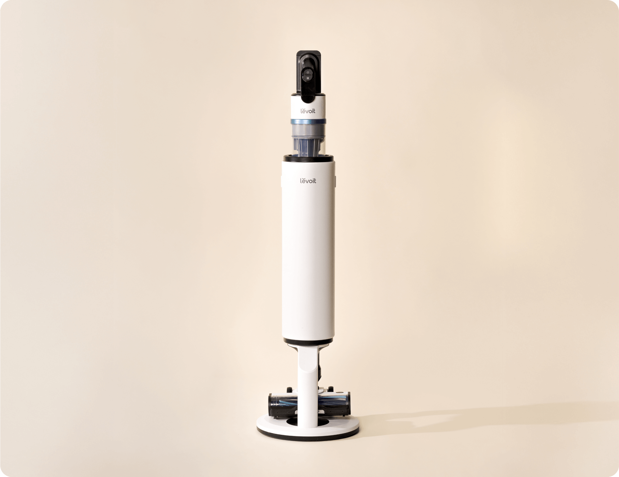 Levoit AERO™ cordless vacuum standing upright on its white docking station.