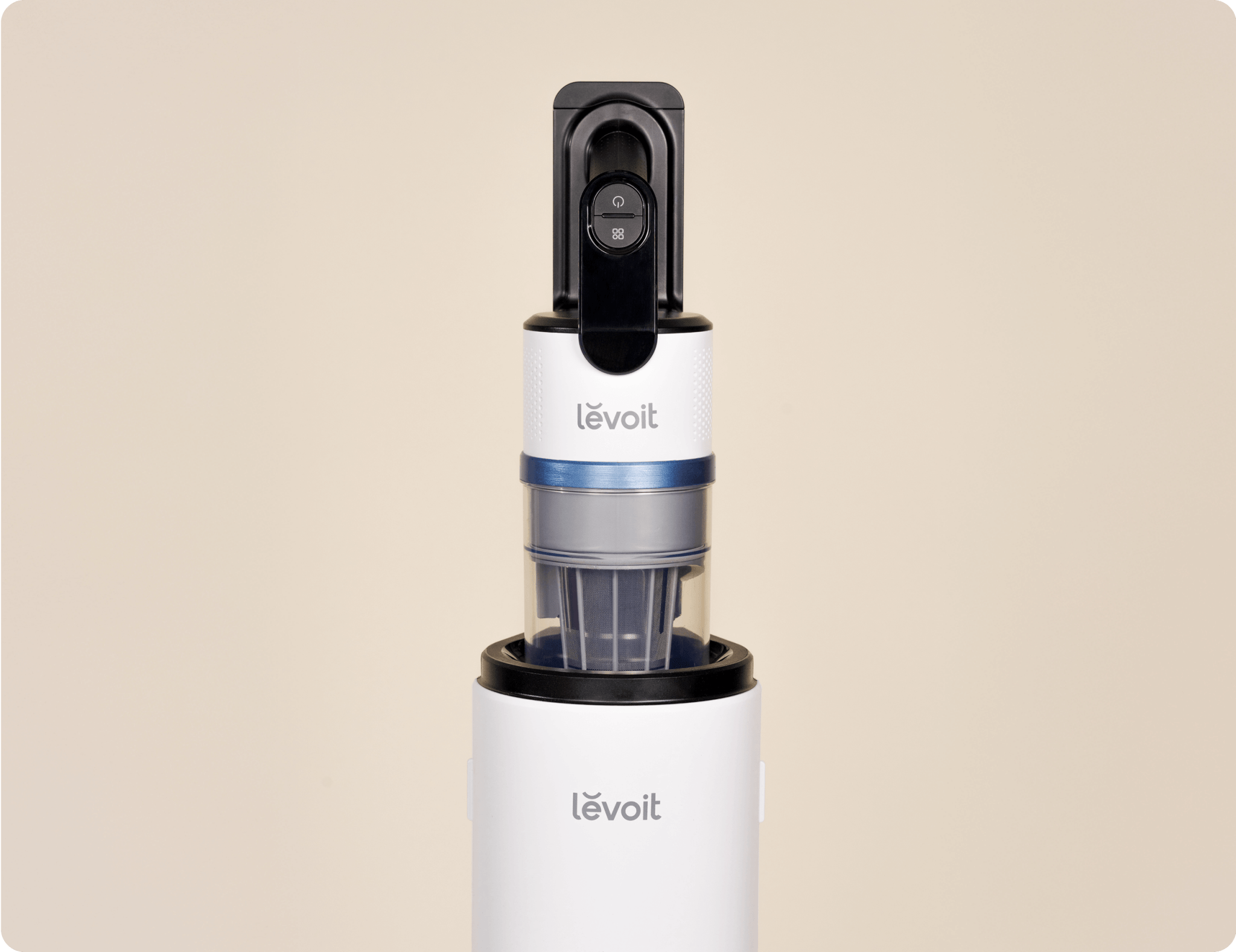 Close-up of Levoit AERO™ cordless vacuum handle and dustbin docked on the auto-empty station.