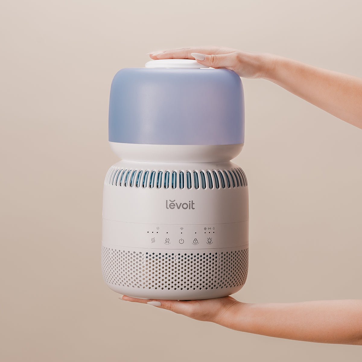 Levoit Sprout Evaporative Humidifier with smart humidity control and auto mode, being adjusted for optimal comfort.