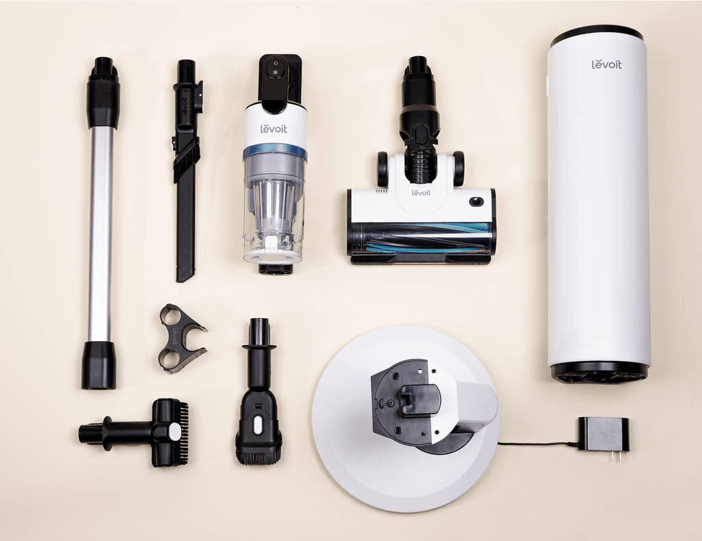 Levoit AERO cordless vacuum parts, accessories, and auto-empty station components arranged flat.
