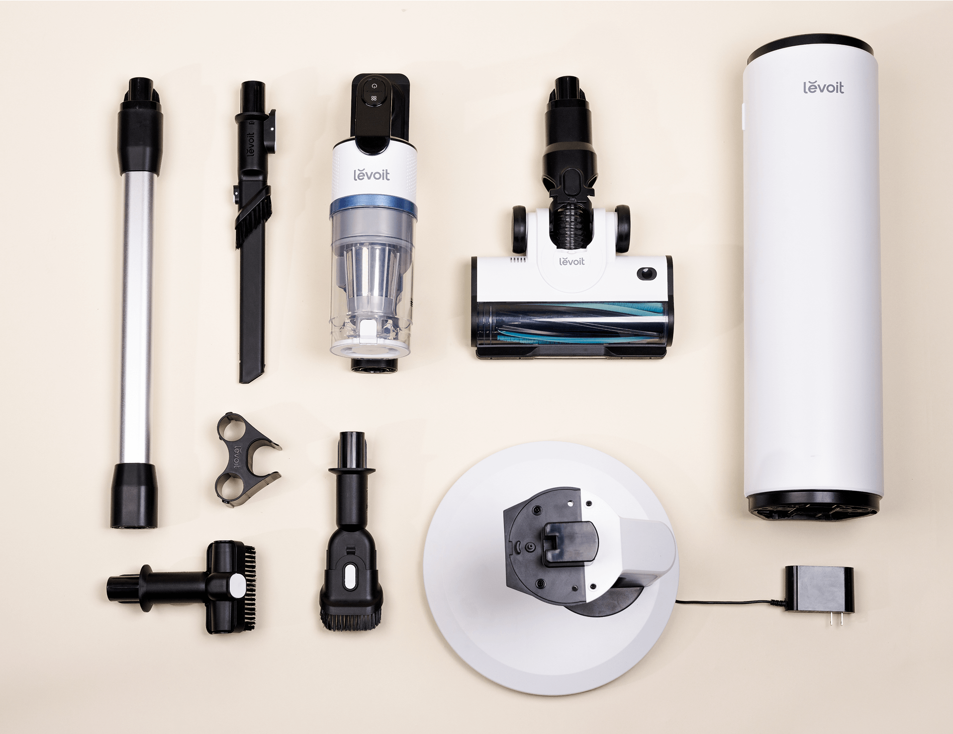 Levoit AERO cordless vacuum parts, accessories, and auto-empty station components arranged flat.