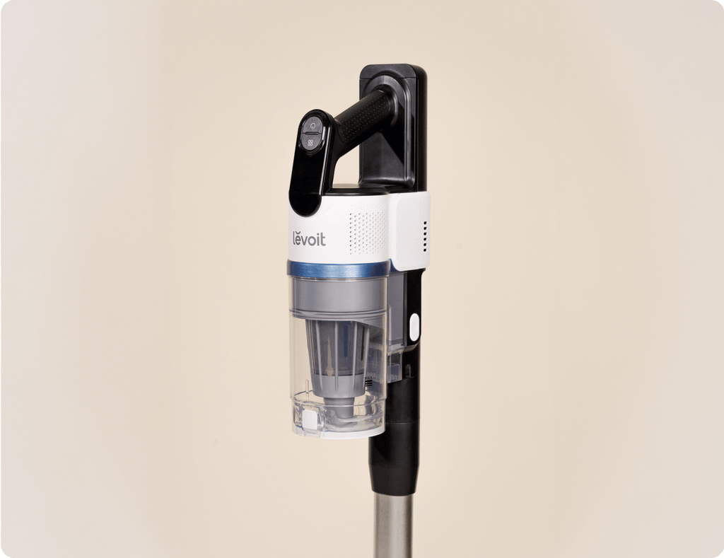 Close-up side view of Levoit AERO™ cordless vacuum handle and dustbin docked on the auto-empty station