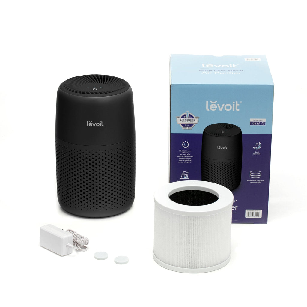 Levoit Core Mini-P Air Purifier with its box and filter, showcasing its filter replacement, and included accessories.